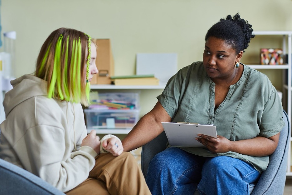 A teacher working with a student returning to school.