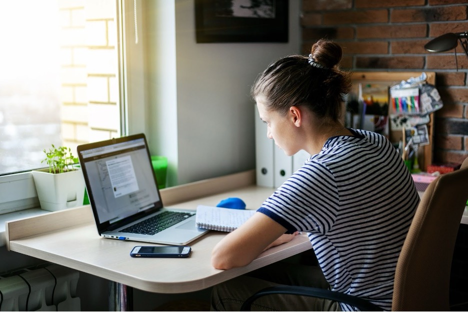 A student working from home on a laptop.